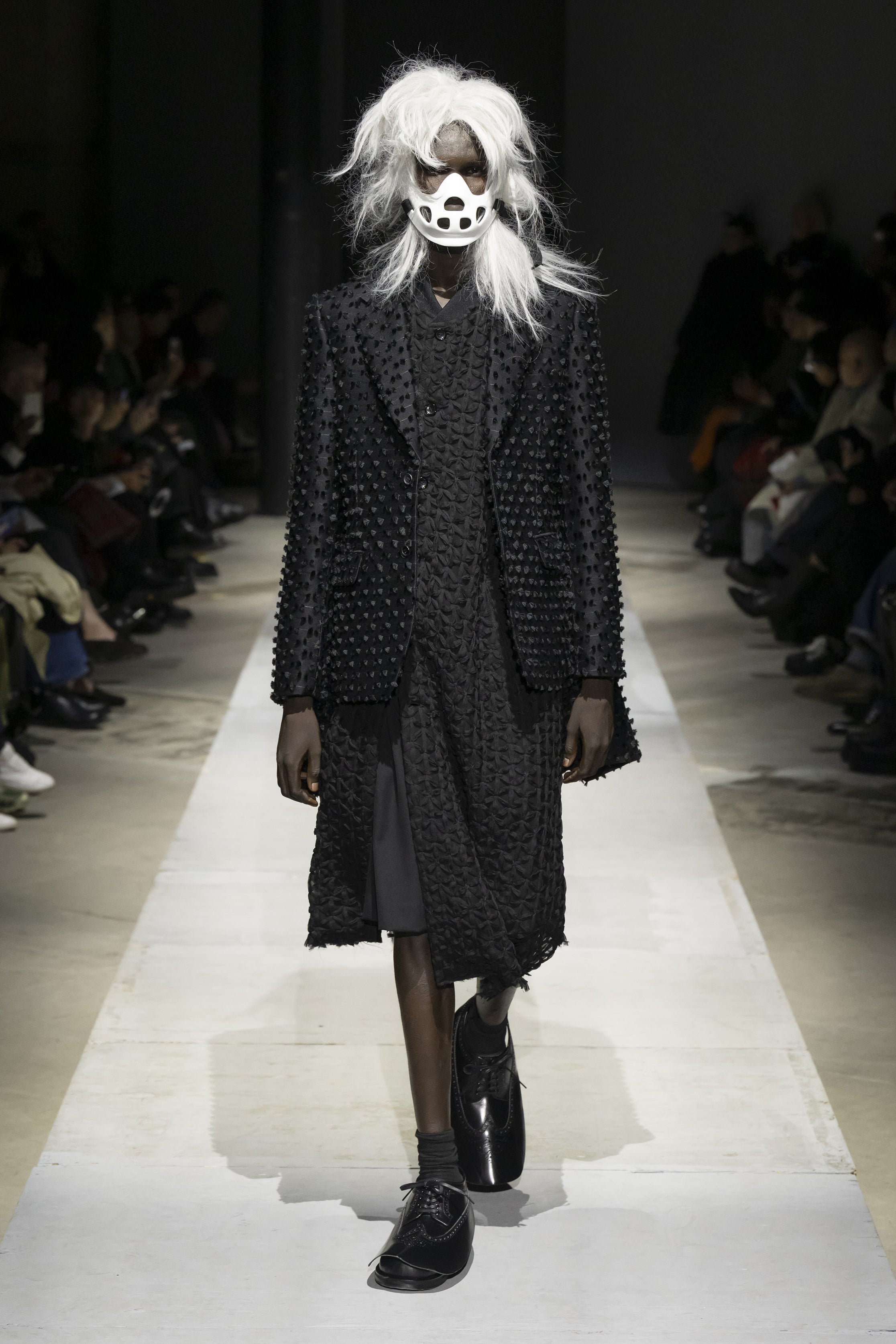 Fashion model wearing a COMME DES GARÇONS HOMME PLUS SS26 outfit