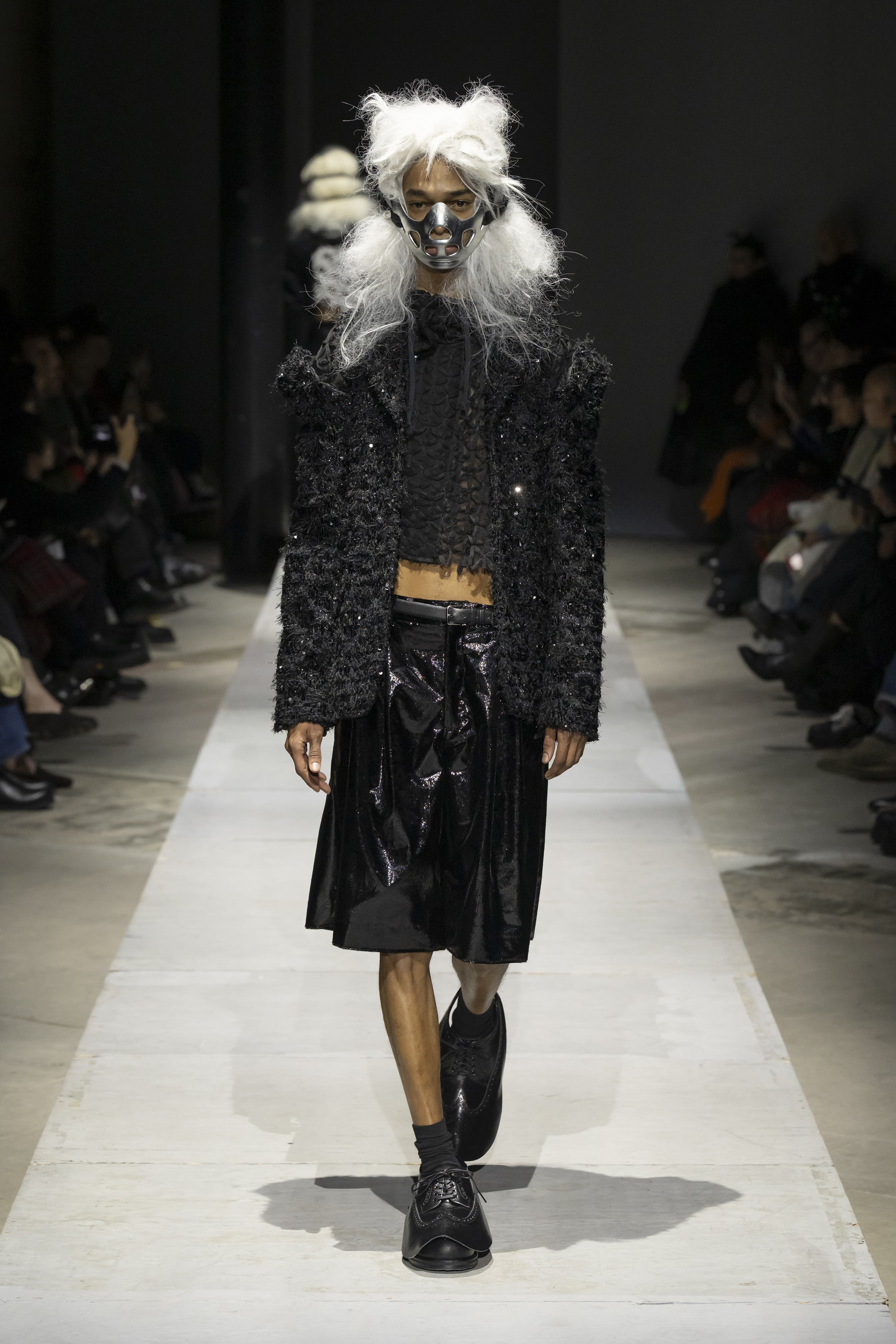 Fashion model wearing a COMME DES GARÇONS HOMME PLUS SS26 outfit