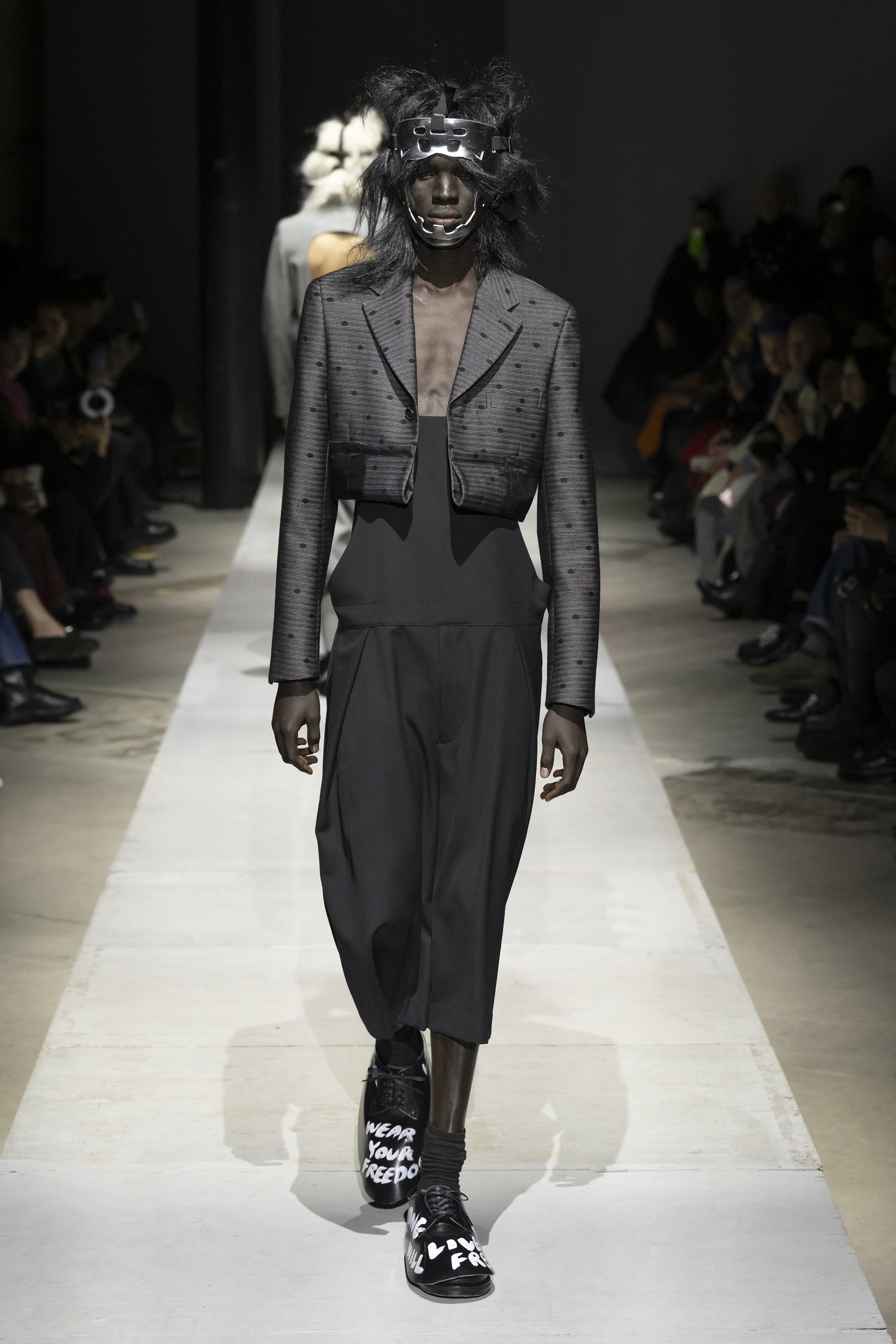 Fashion model wearing a COMME DES GARÇONS HOMME PLUS SS26 outfit