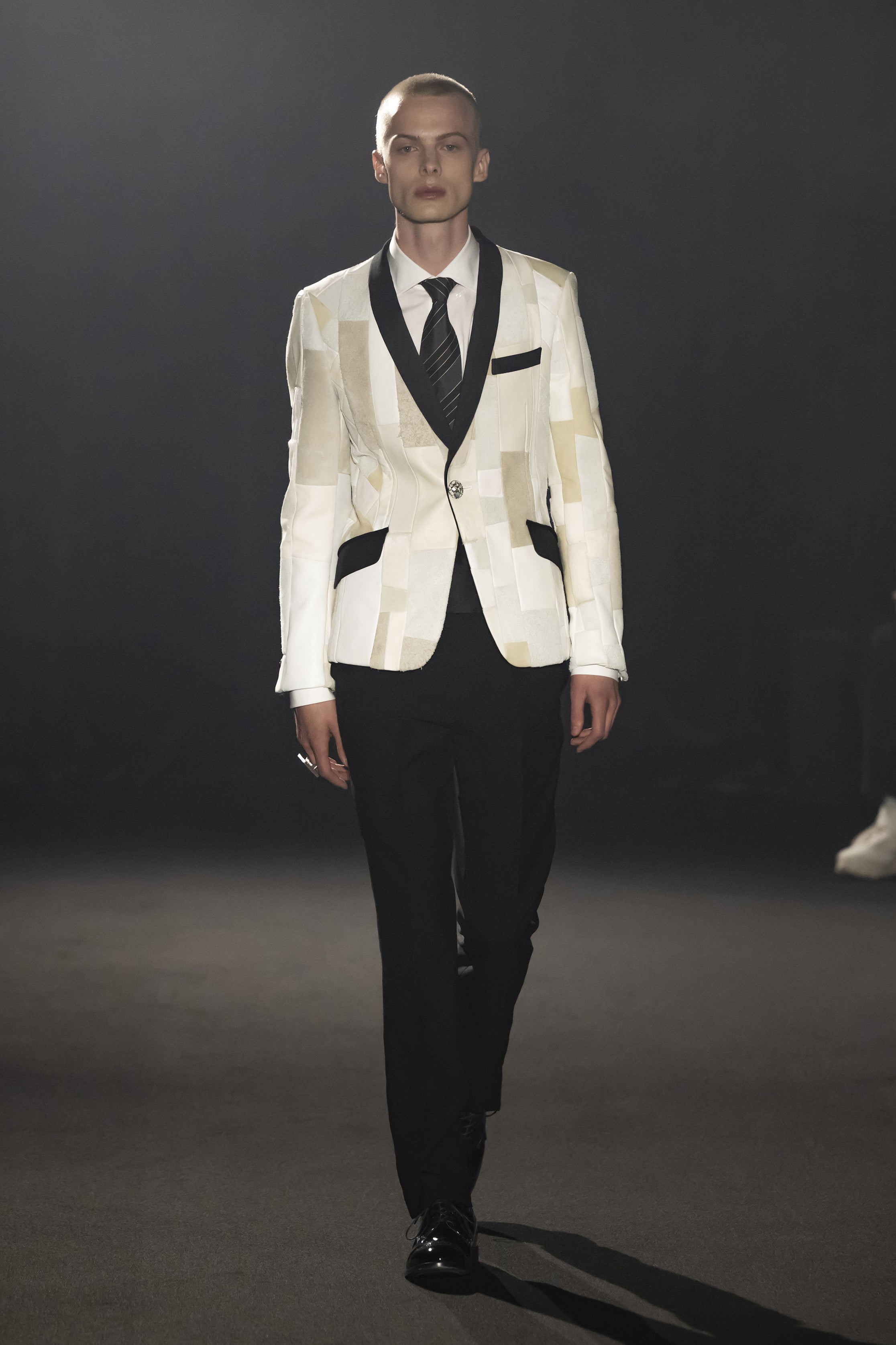 Fashion model wearing a JUNYA WATANABE MAN AW26 outfit