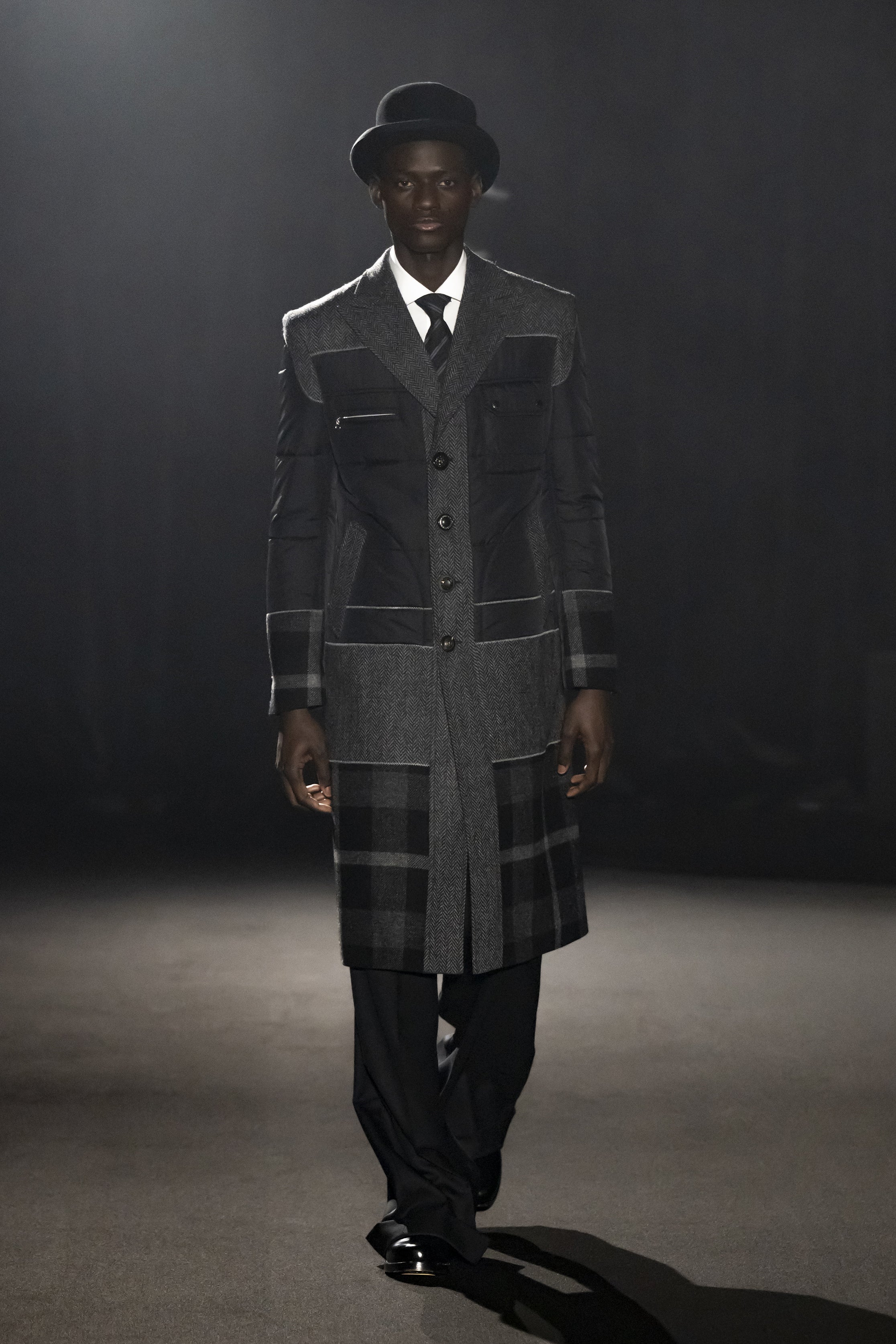 Fashion model wearing a JUNYA WATANABE MAN AW26 outfit