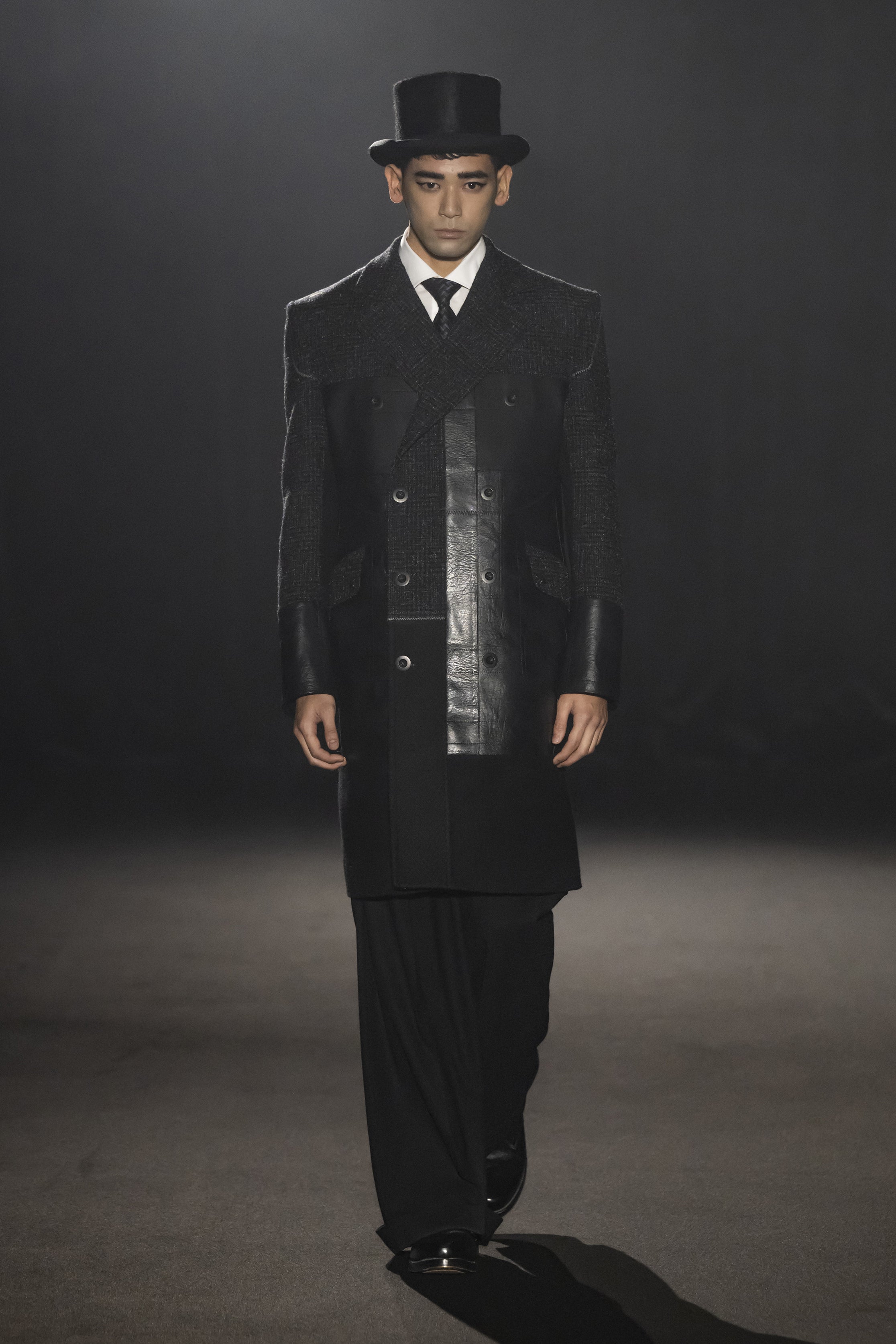 Fashion model wearing a JUNYA WATANABE MAN AW26 outfit