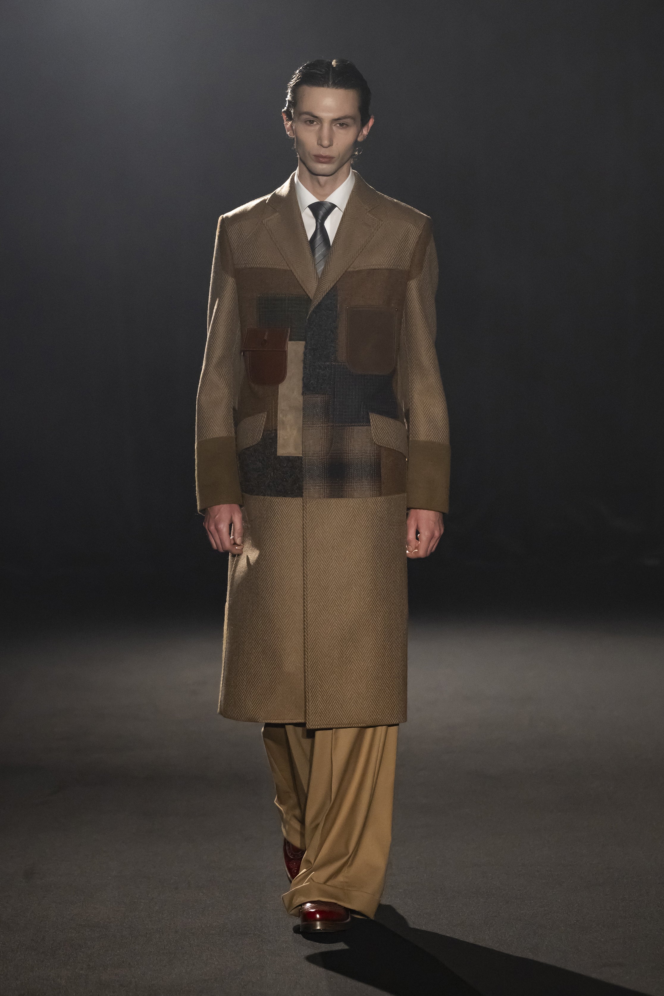 Fashion model wearing a JUNYA WATANABE MAN AW26 outfit