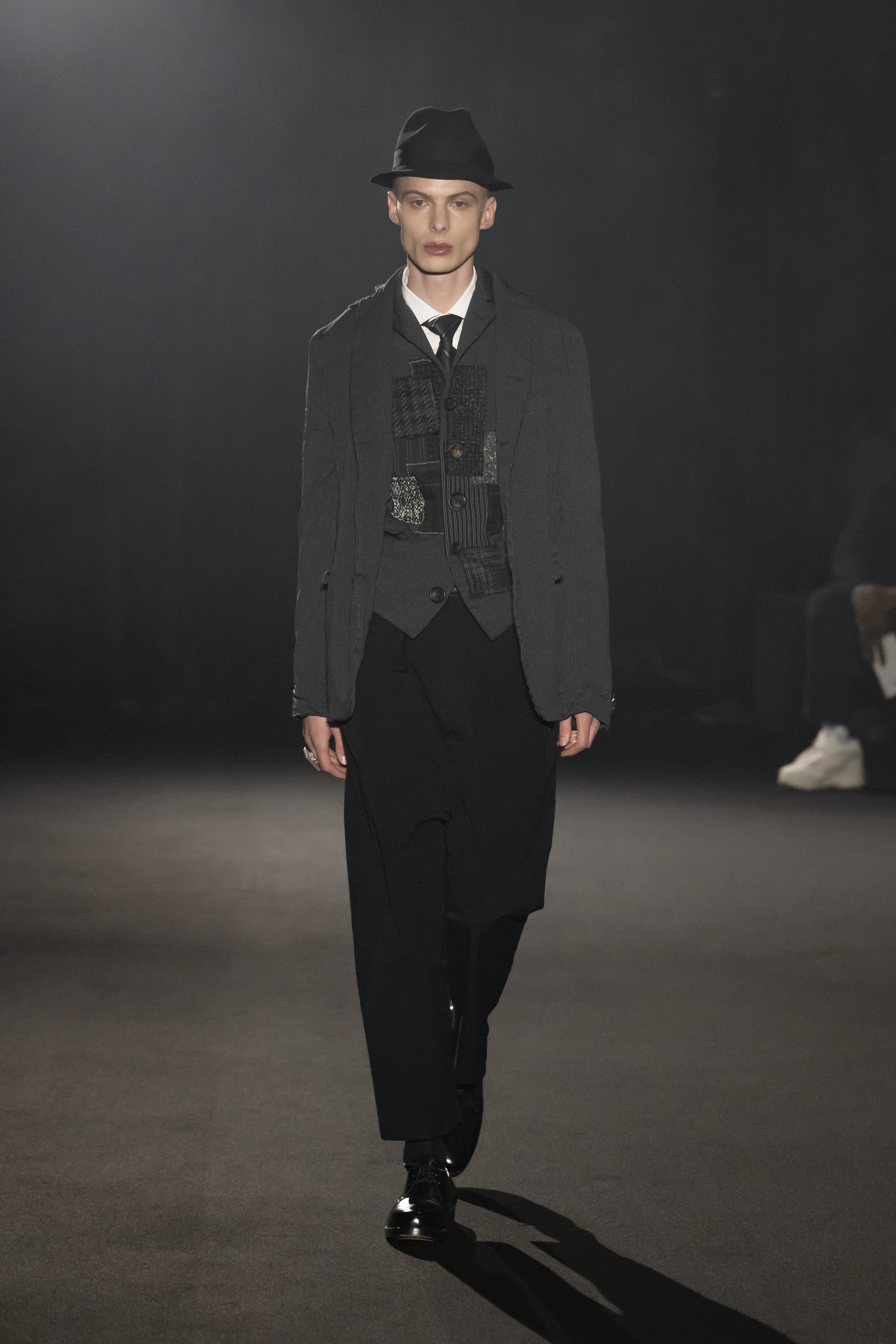 Fashion model wearing a JUNYA WATANABE MAN AW26 outfit