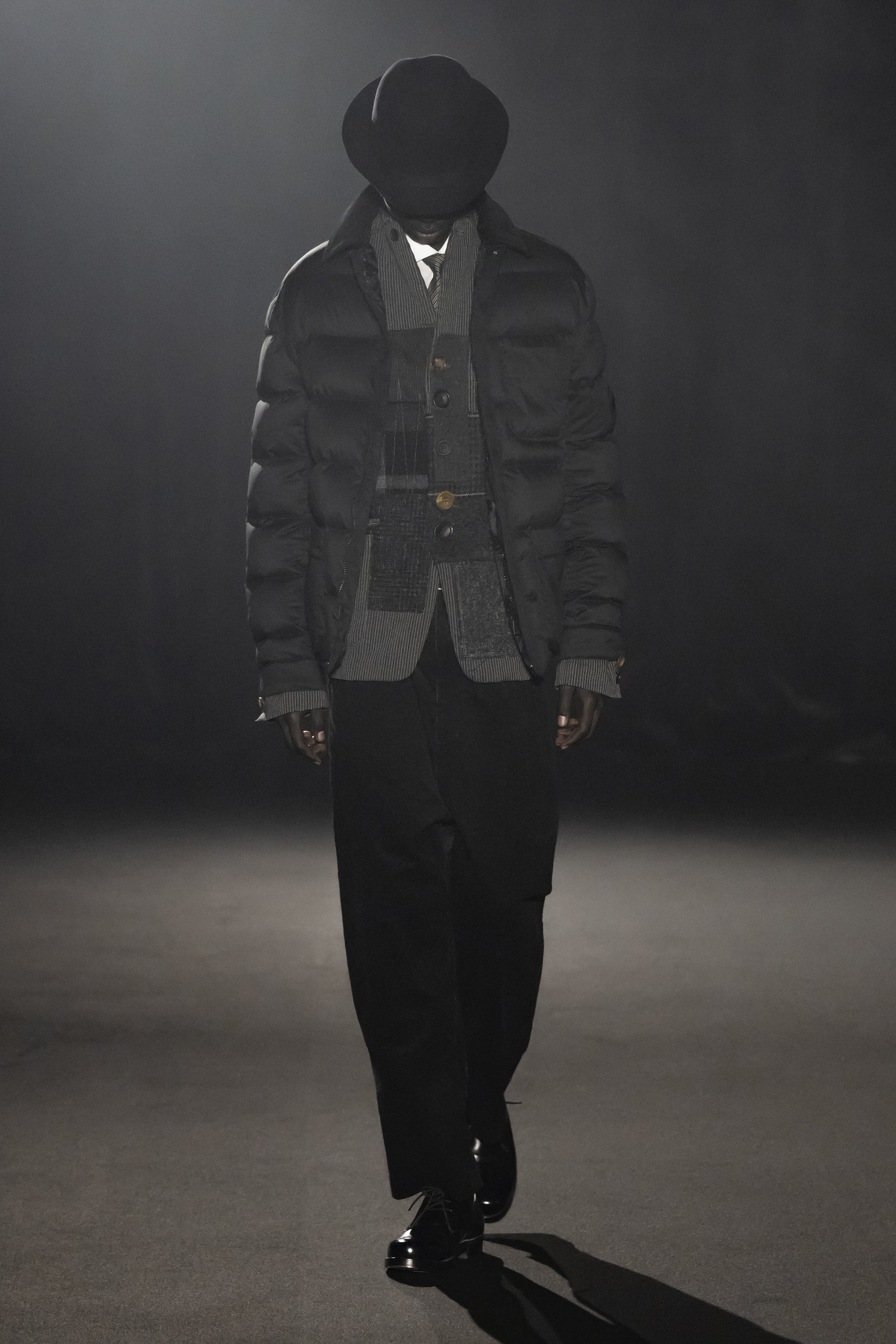 Fashion model wearing a JUNYA WATANABE MAN AW26 outfit