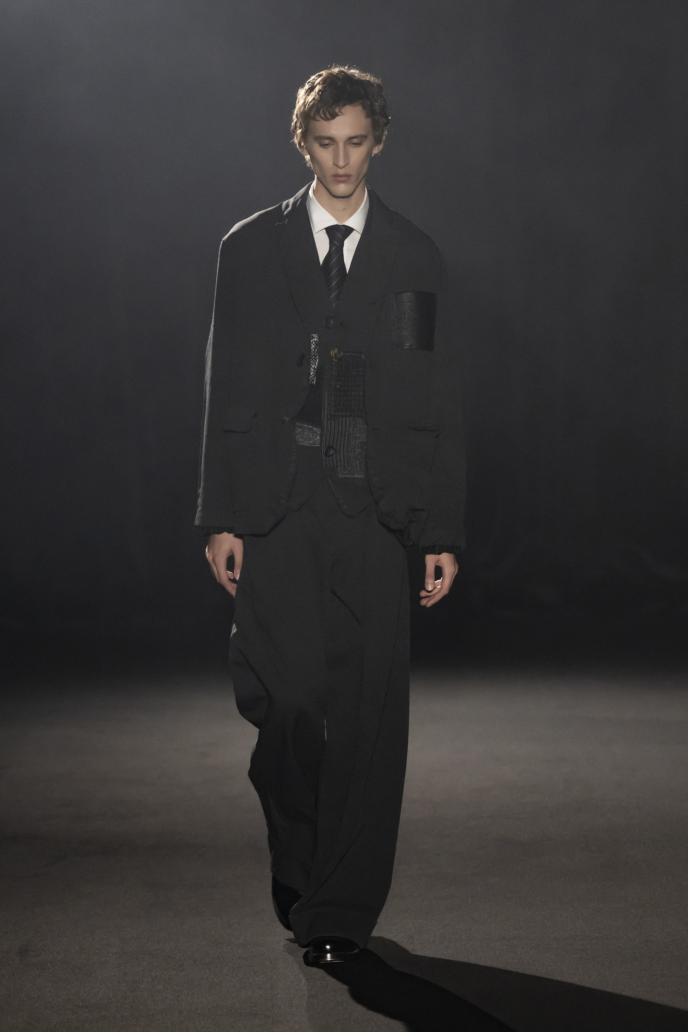 Fashion model wearing a JUNYA WATANABE MAN AW26 outfit