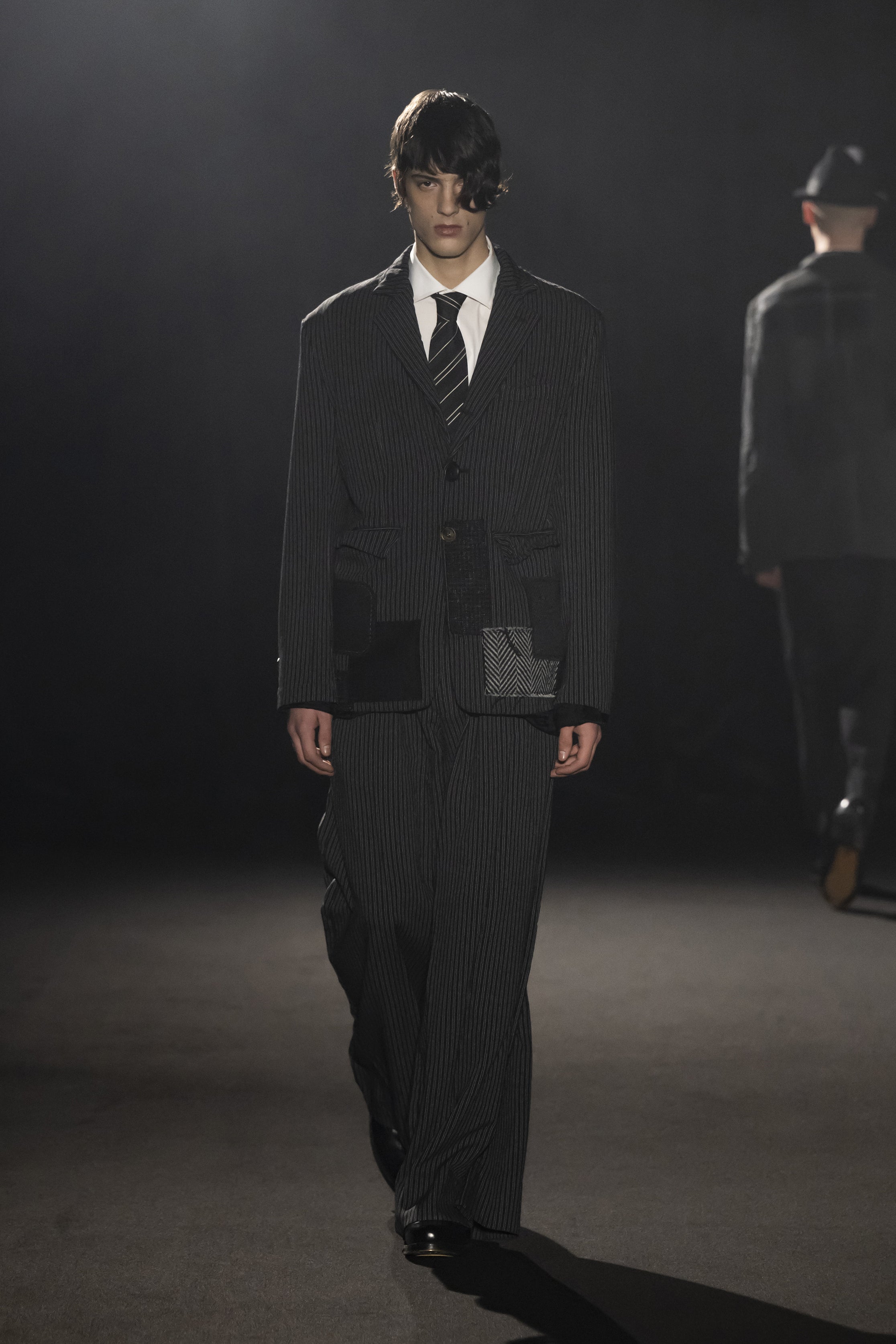 Fashion model wearing a JUNYA WATANABE MAN AW26 outfit