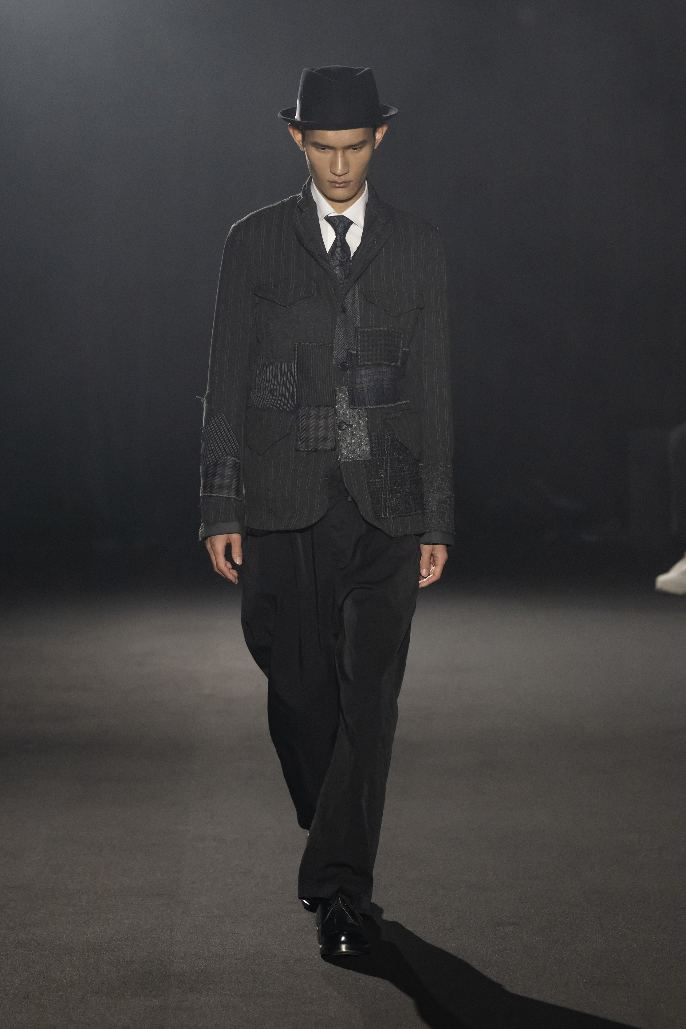 Fashion model wearing a JUNYA WATANABE MAN AW26 outfit