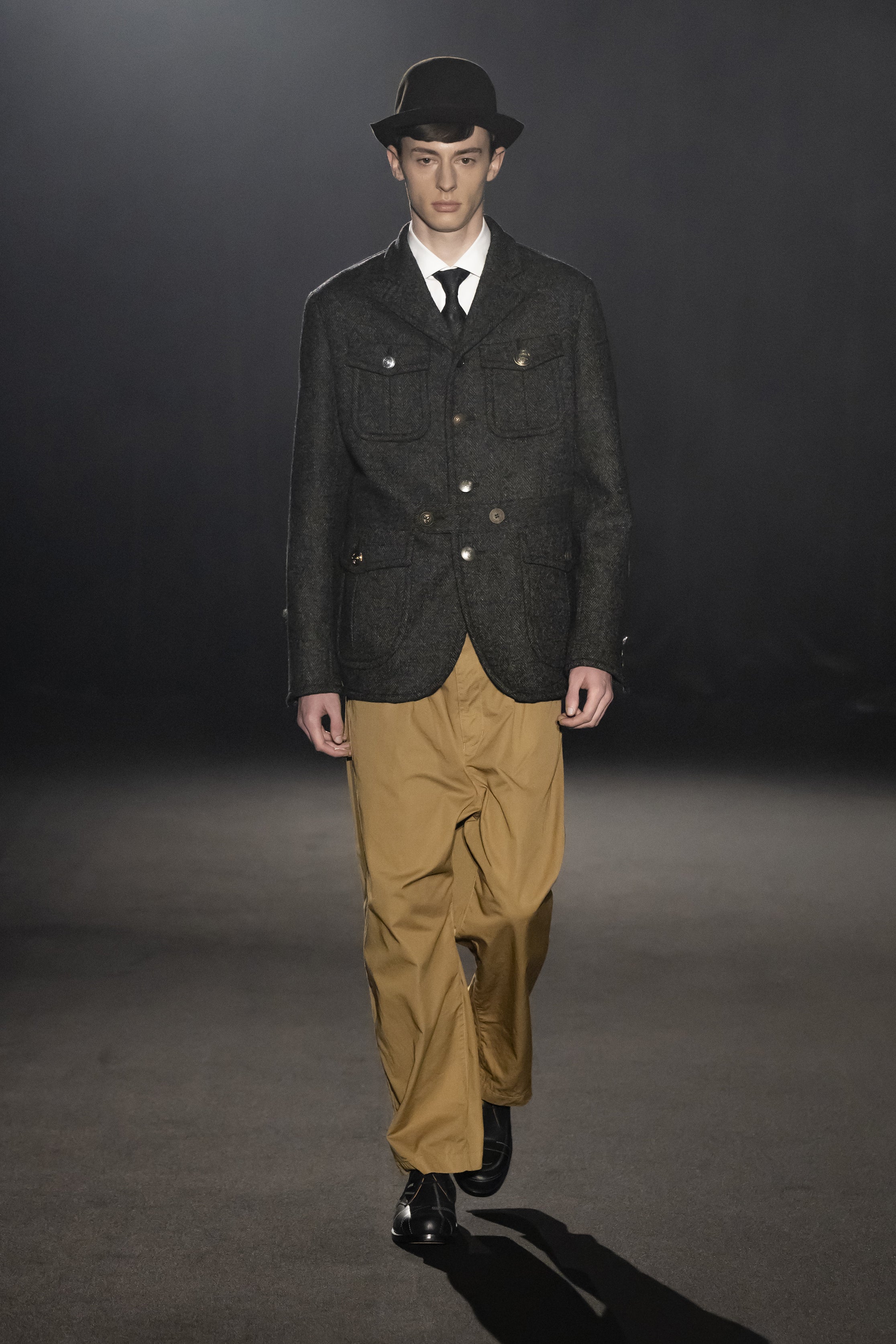 Fashion model wearing a JUNYA WATANABE MAN AW26 outfit