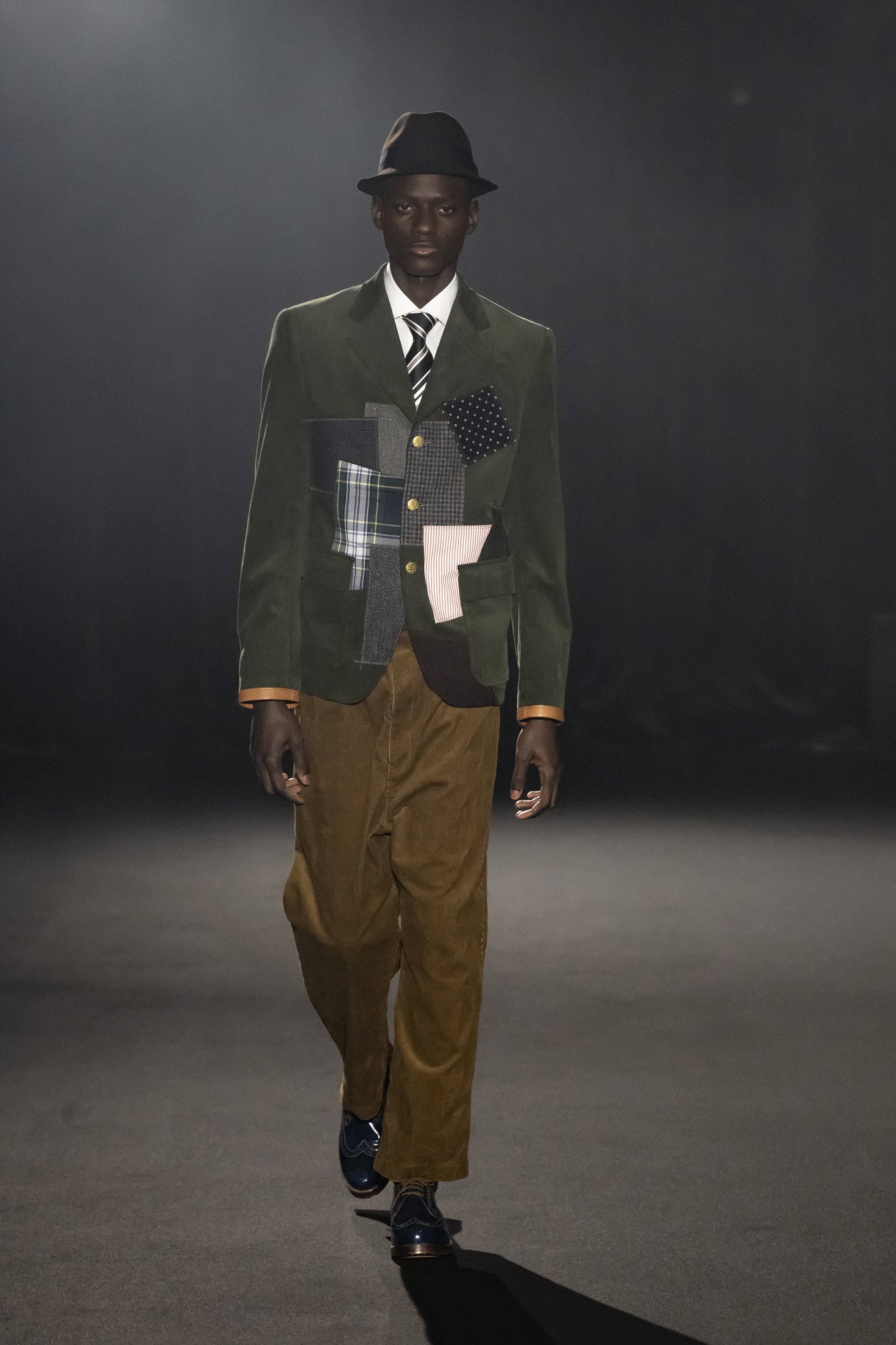 Fashion model wearing a JUNYA WATANABE MAN AW26 outfit