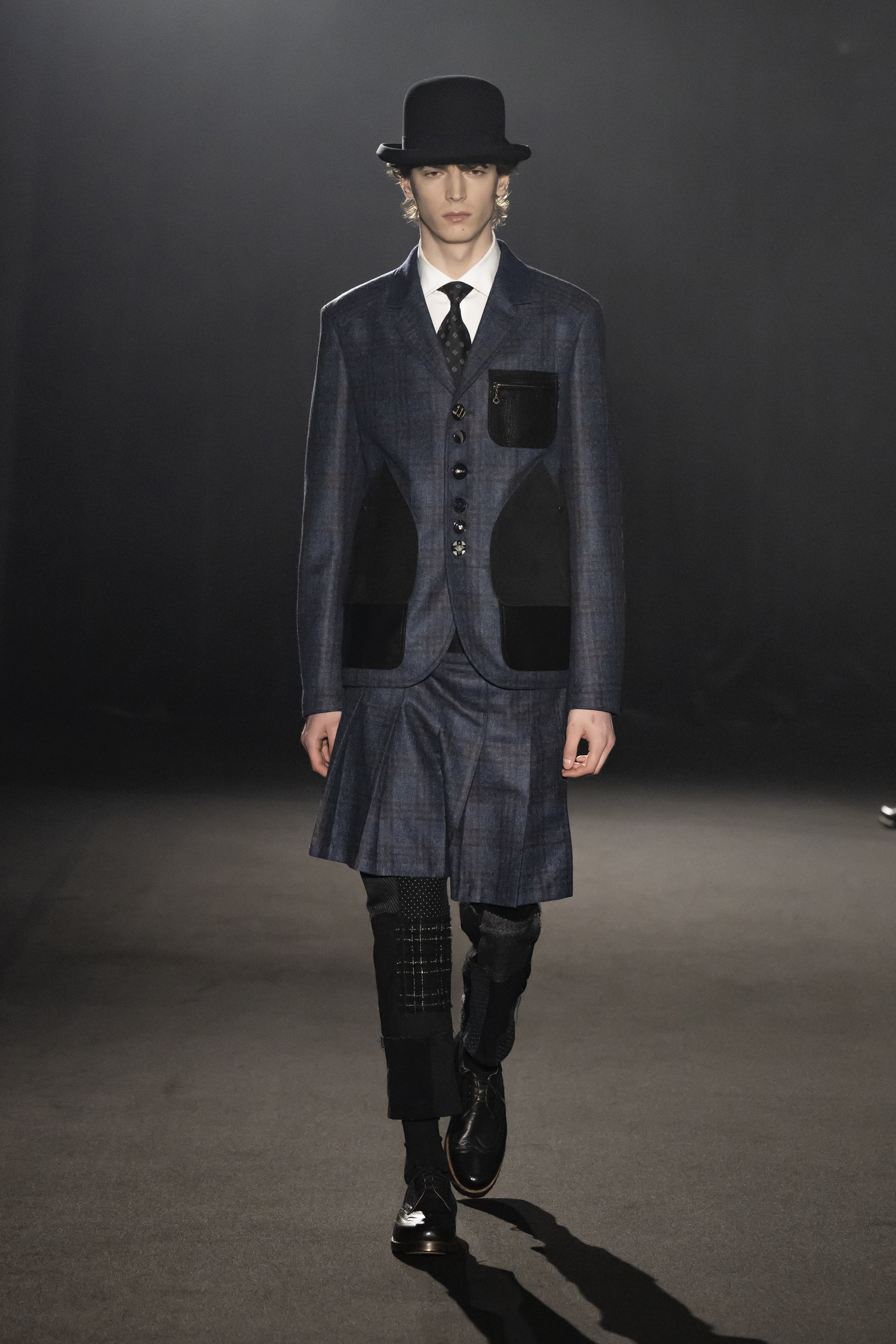 Fashion model wearing a JUNYA WATANABE MAN AW26 outfit