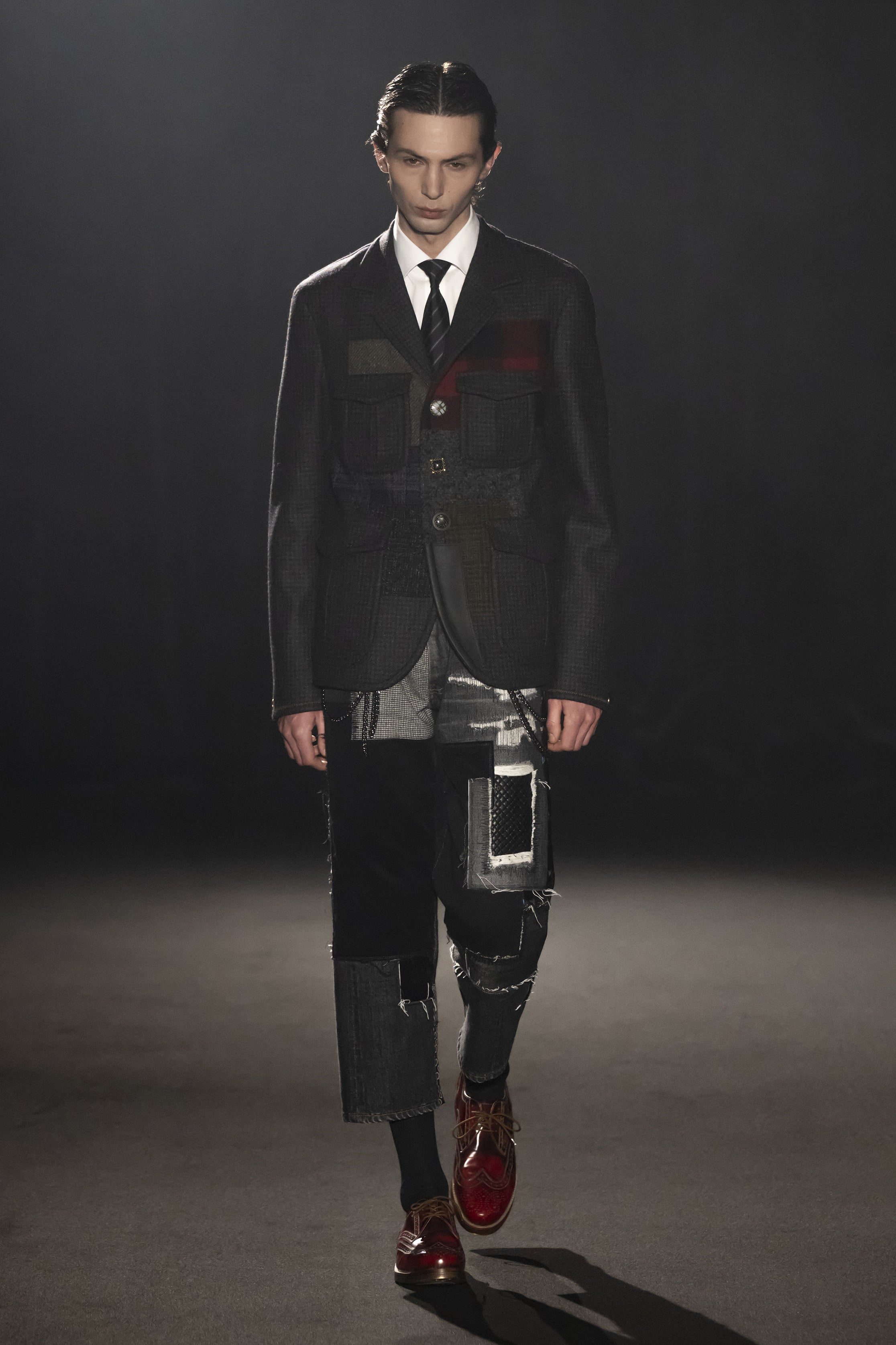 Fashion model wearing a JUNYA WATANABE MAN AW26 outfit