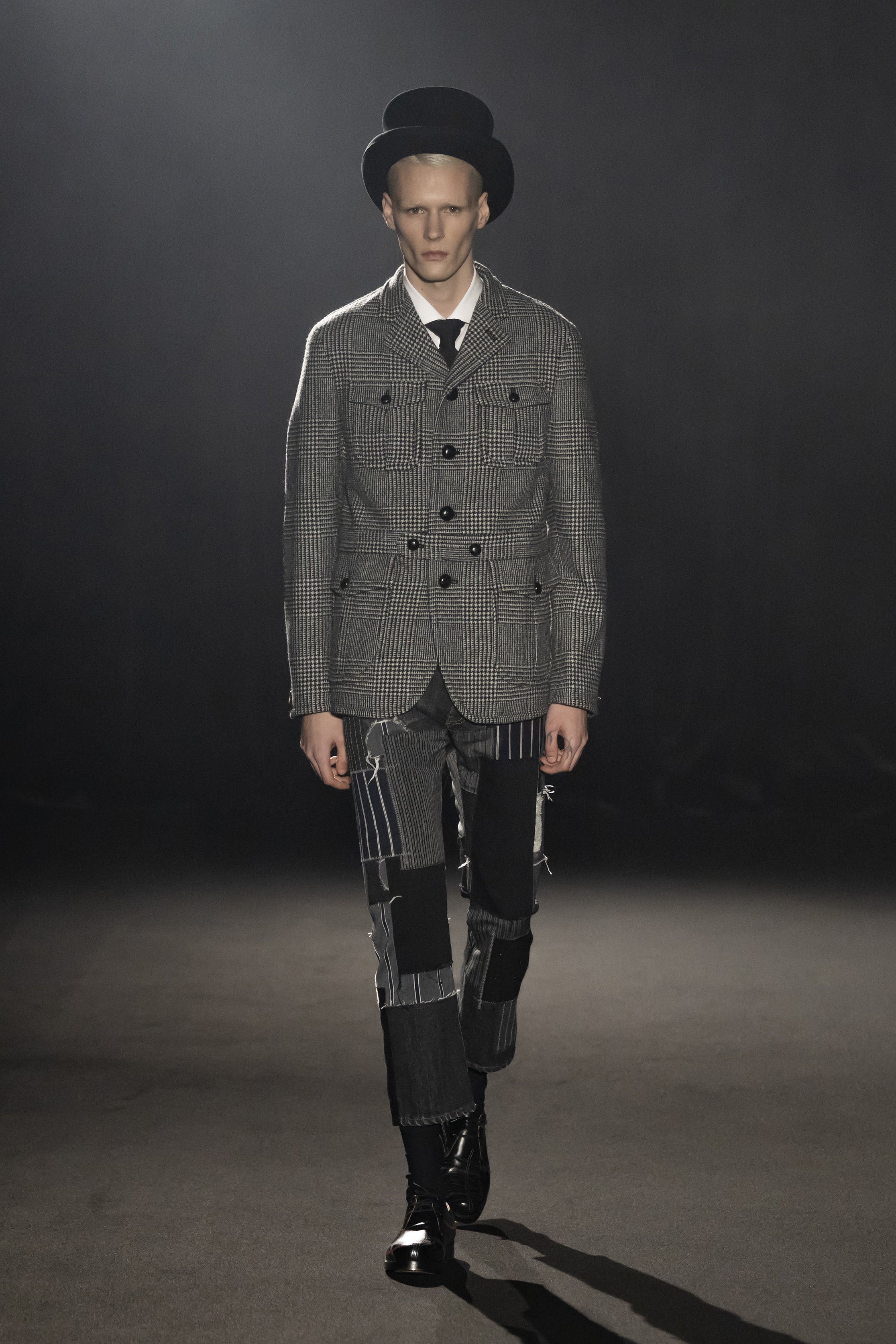 Fashion model wearing a JUNYA WATANABE MAN AW26 outfit