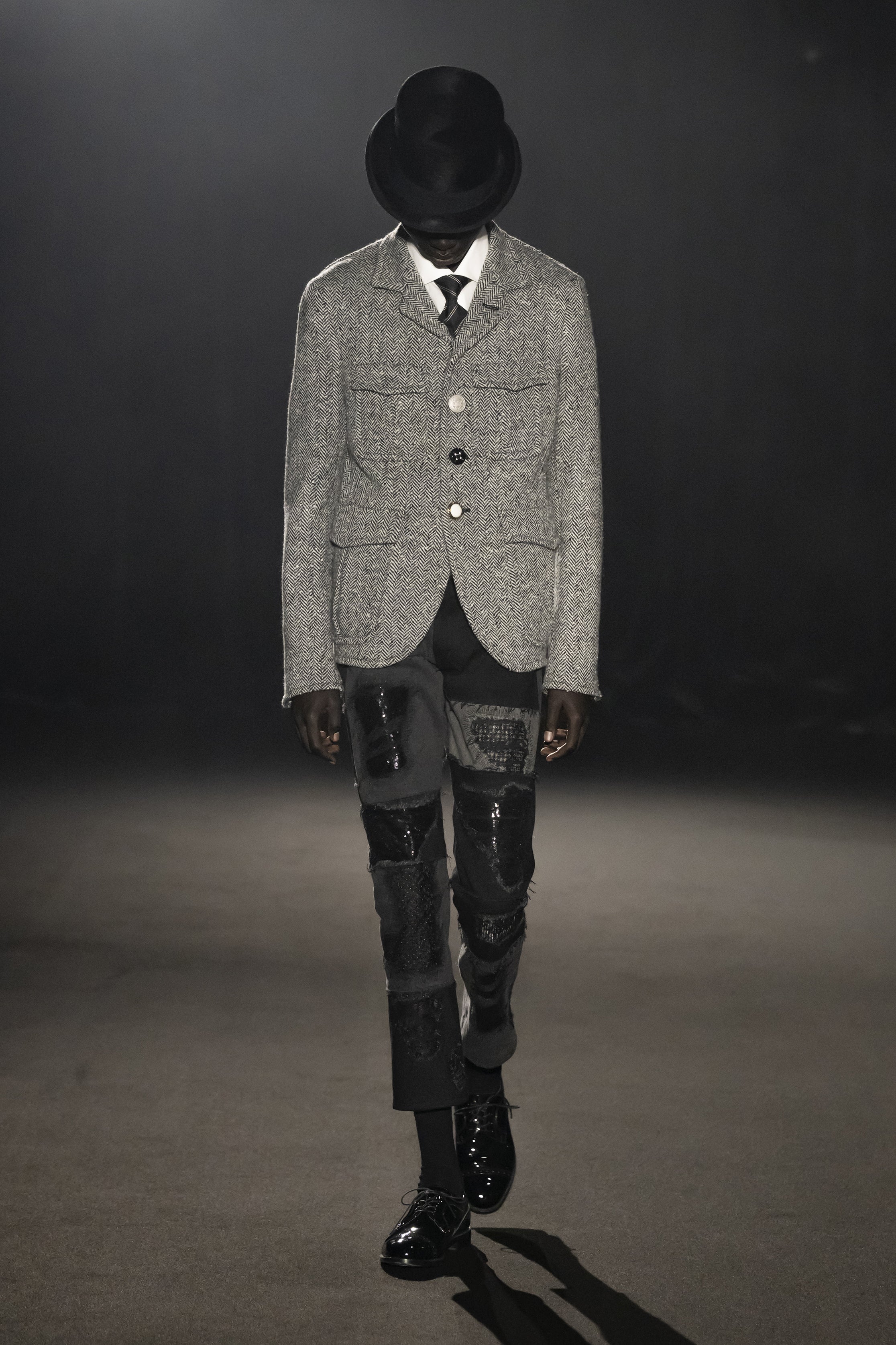 Fashion model wearing a JUNYA WATANABE MAN AW26 outfit
