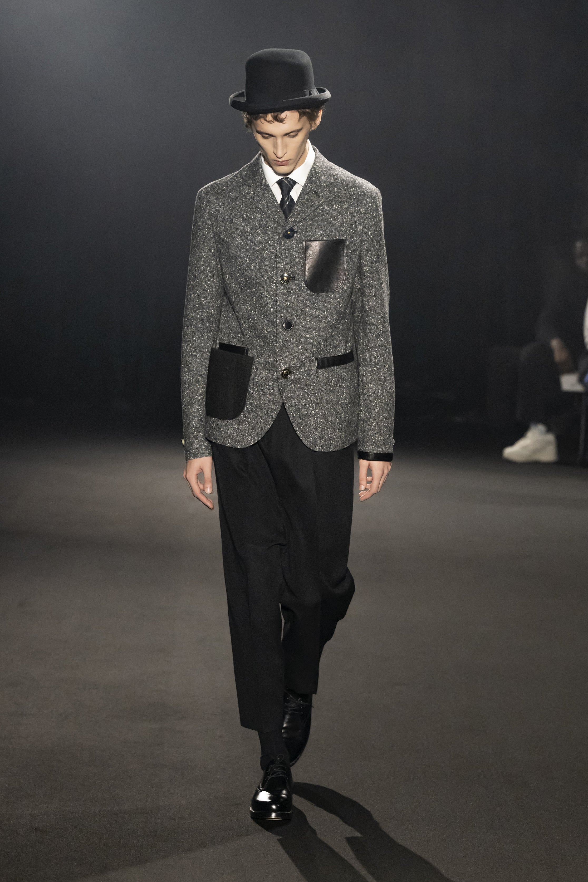 Fashion model wearing a JUNYA WATANABE MAN AW26 outfit