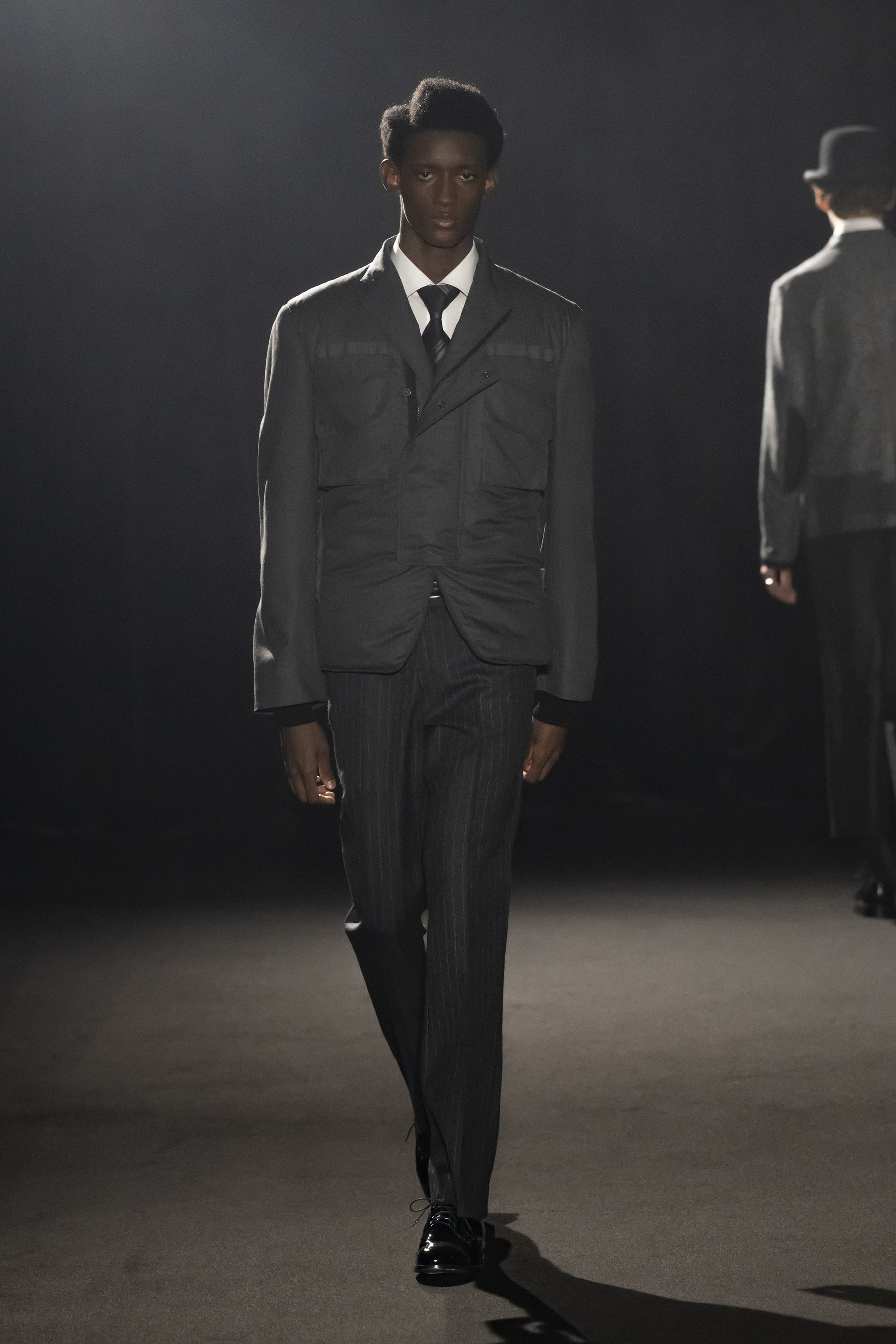 Fashion model wearing a JUNYA WATANABE MAN AW26 outfit