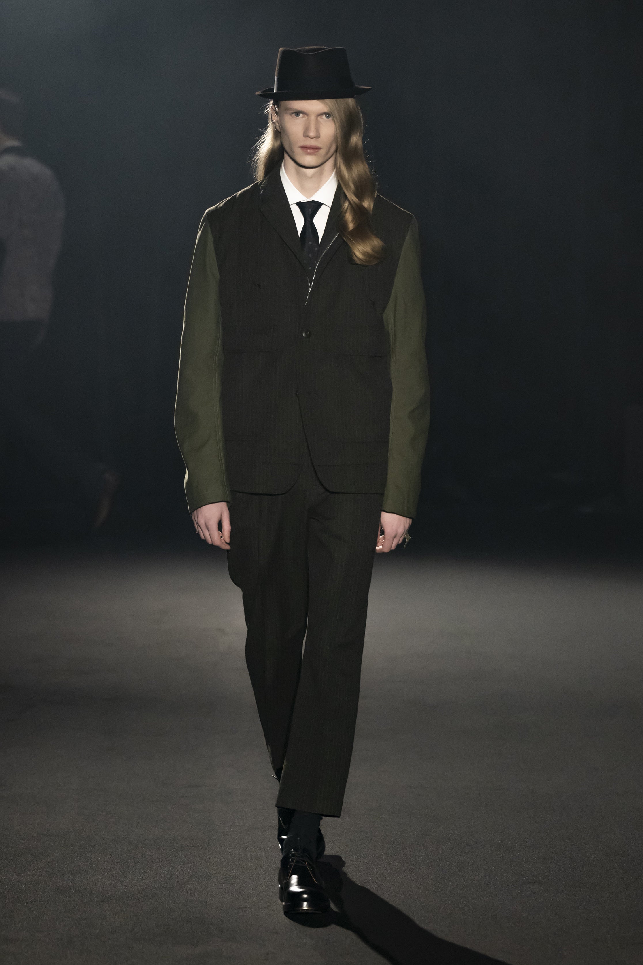Fashion model wearing a JUNYA WATANABE MAN AW26 outfit