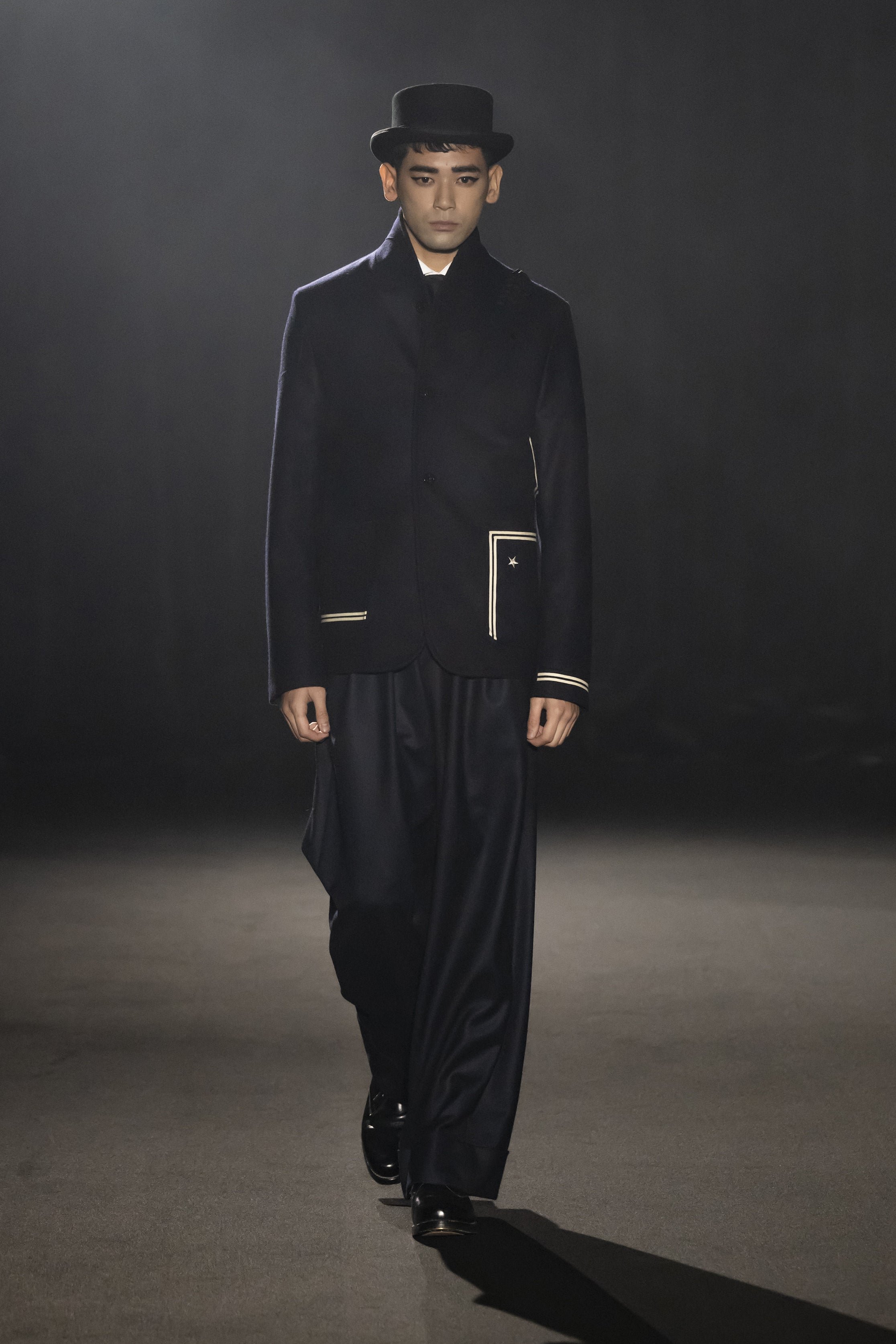 Fashion model wearing a JUNYA WATANABE MAN AW26 outfit