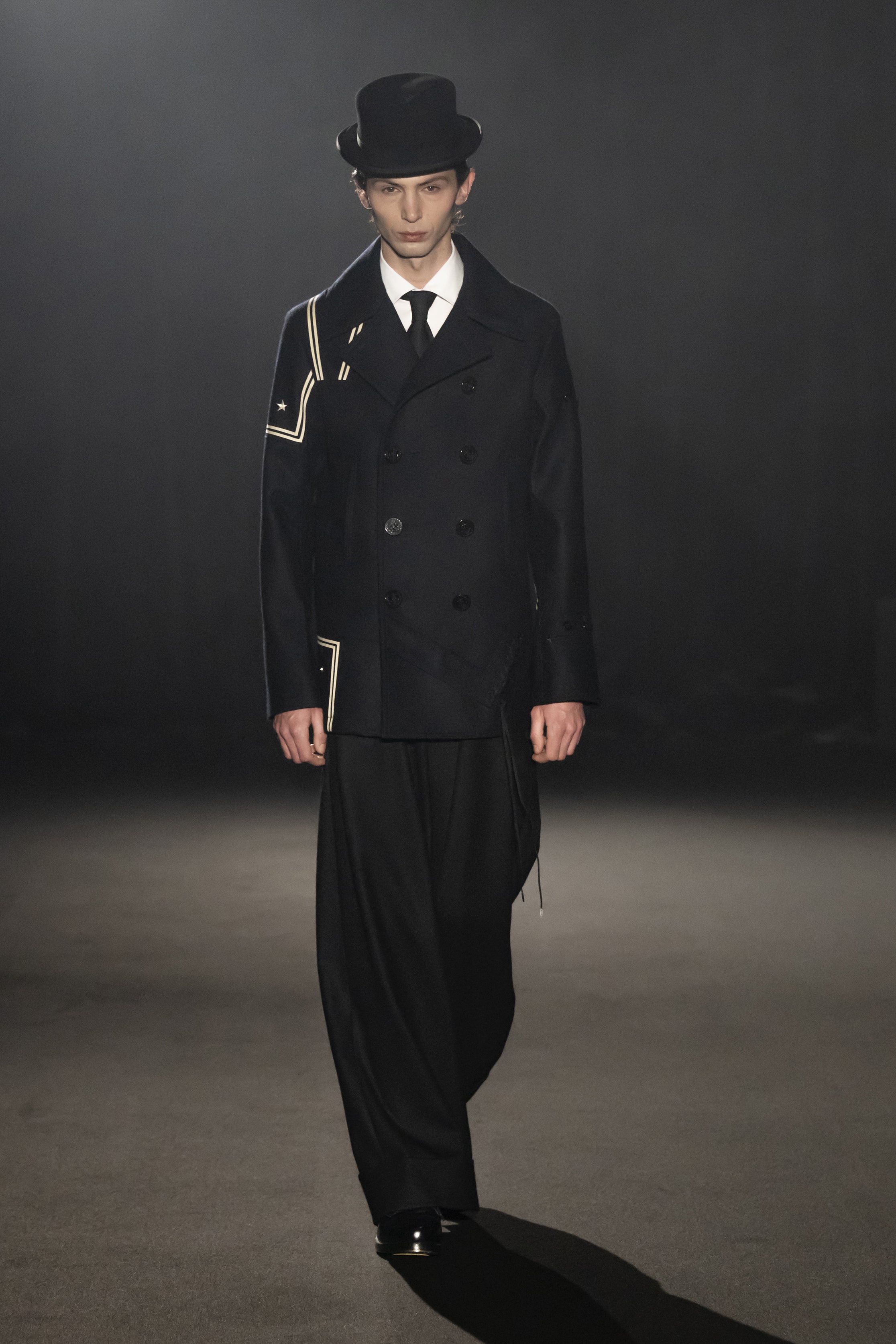 Fashion model wearing a JUNYA WATANABE MAN AW26 outfit