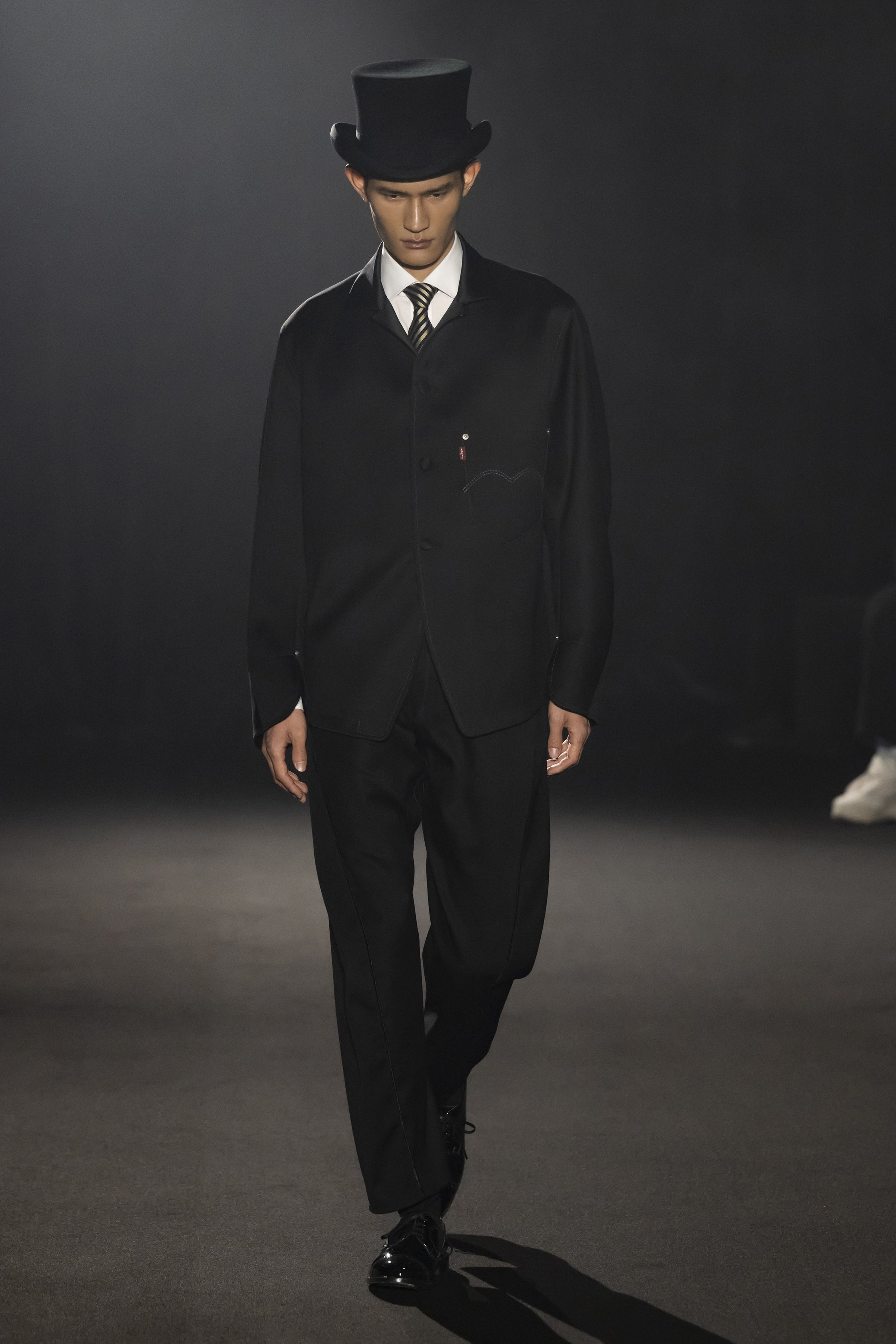 Fashion model wearing a JUNYA WATANABE MAN AW26 outfit