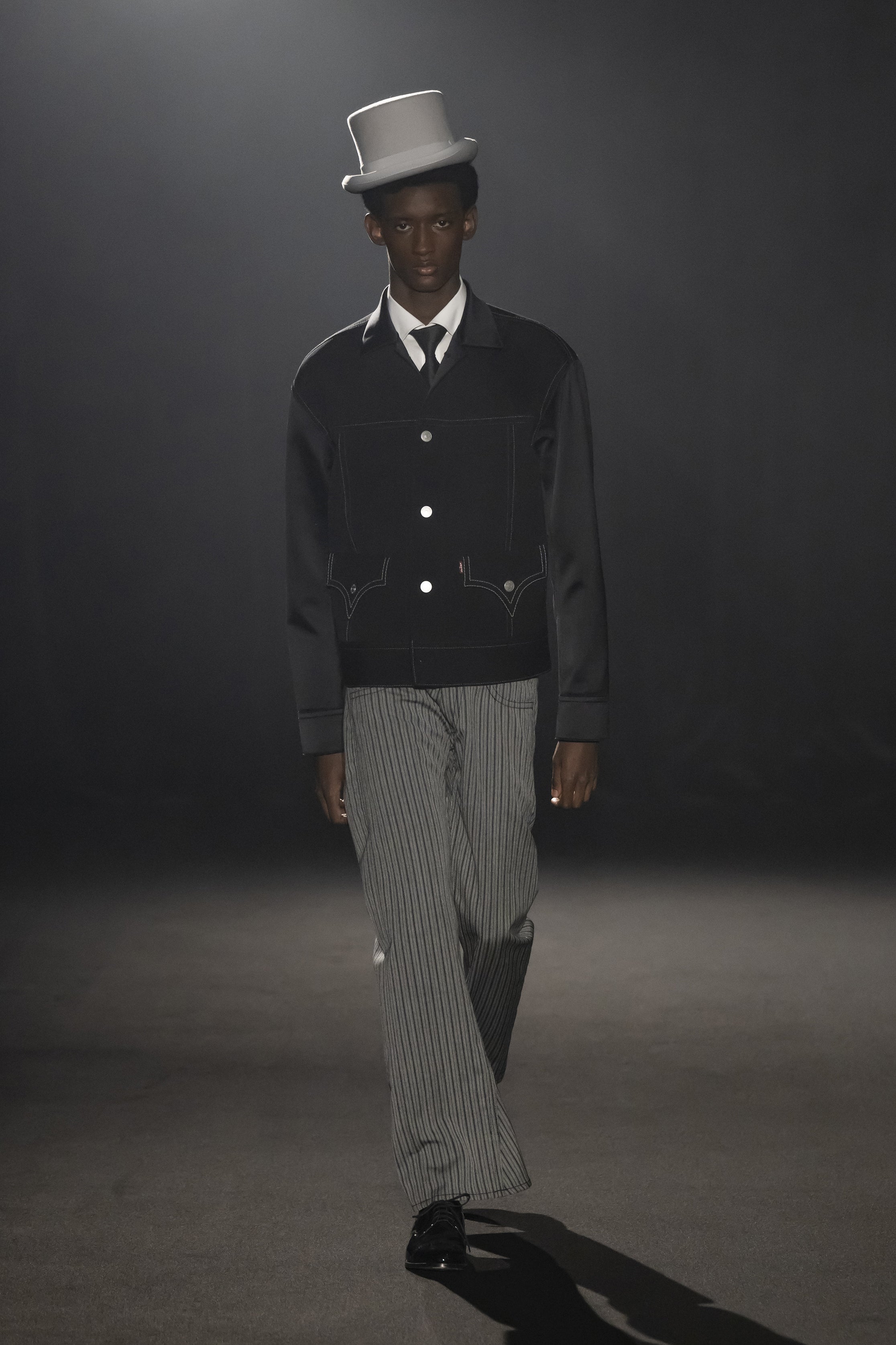 Fashion model wearing a JUNYA WATANABE MAN AW26 outfit