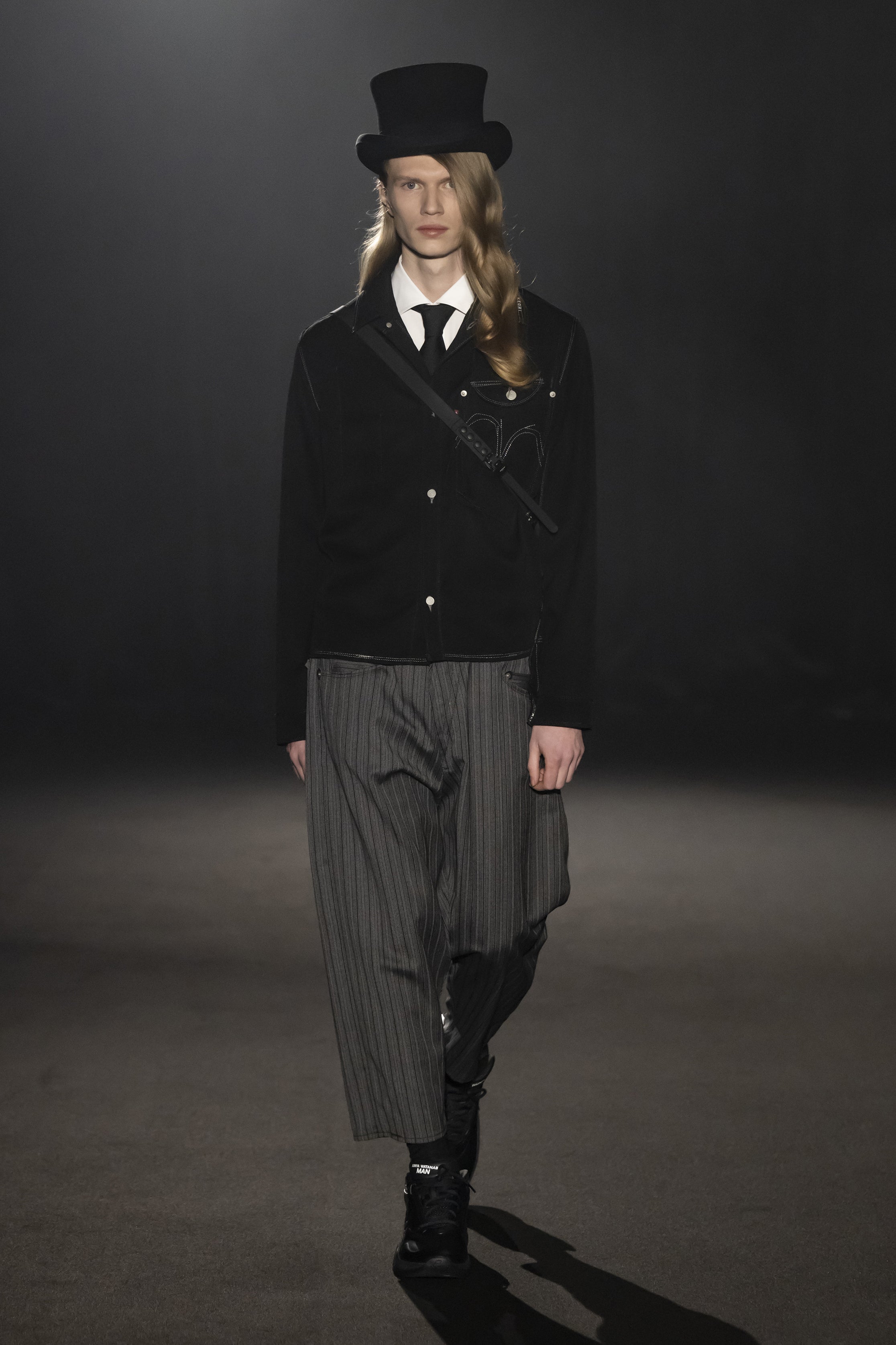 Fashion model wearing a JUNYA WATANABE MAN AW26 outfit
