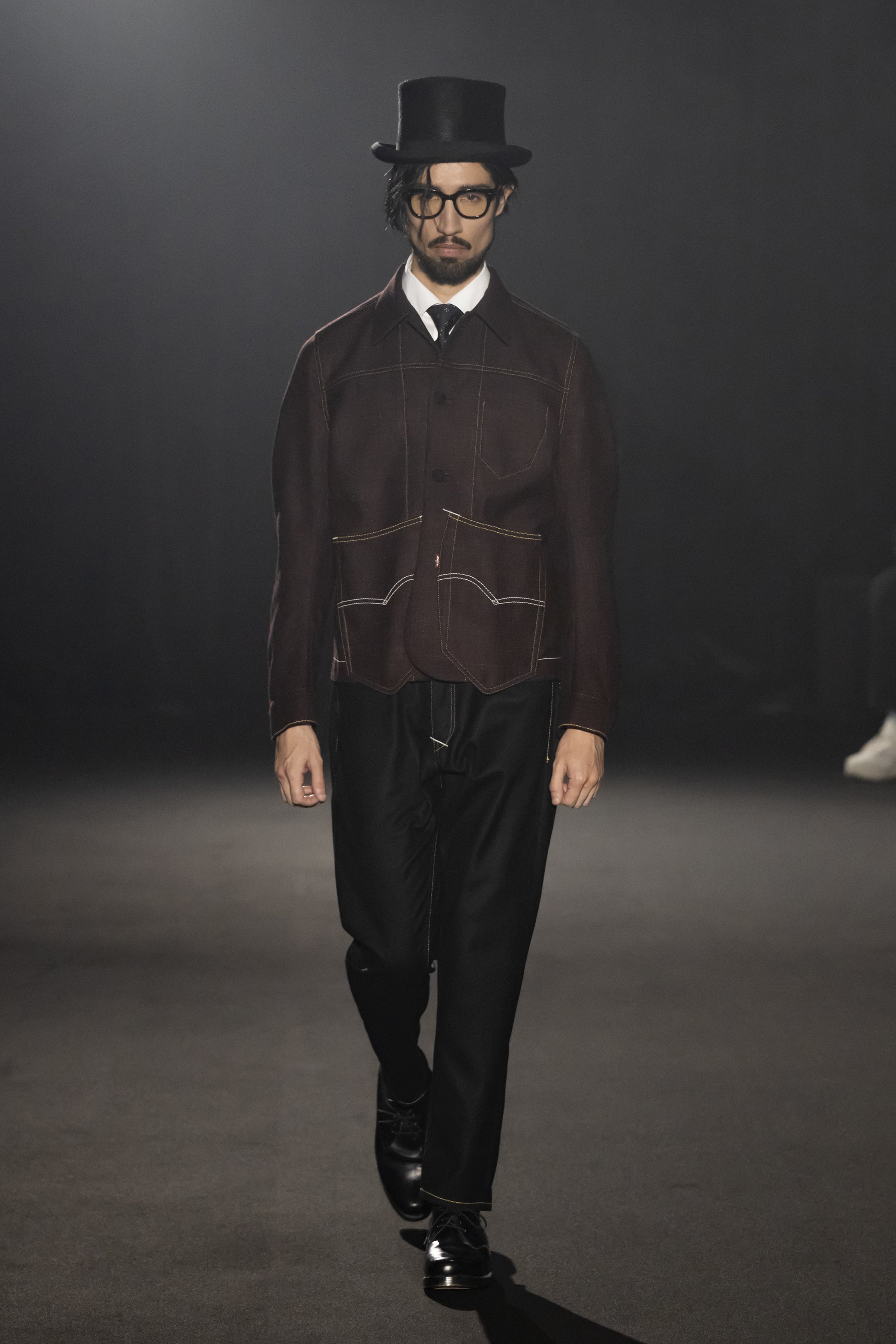 Fashion model wearing a JUNYA WATANABE MAN AW26 outfit