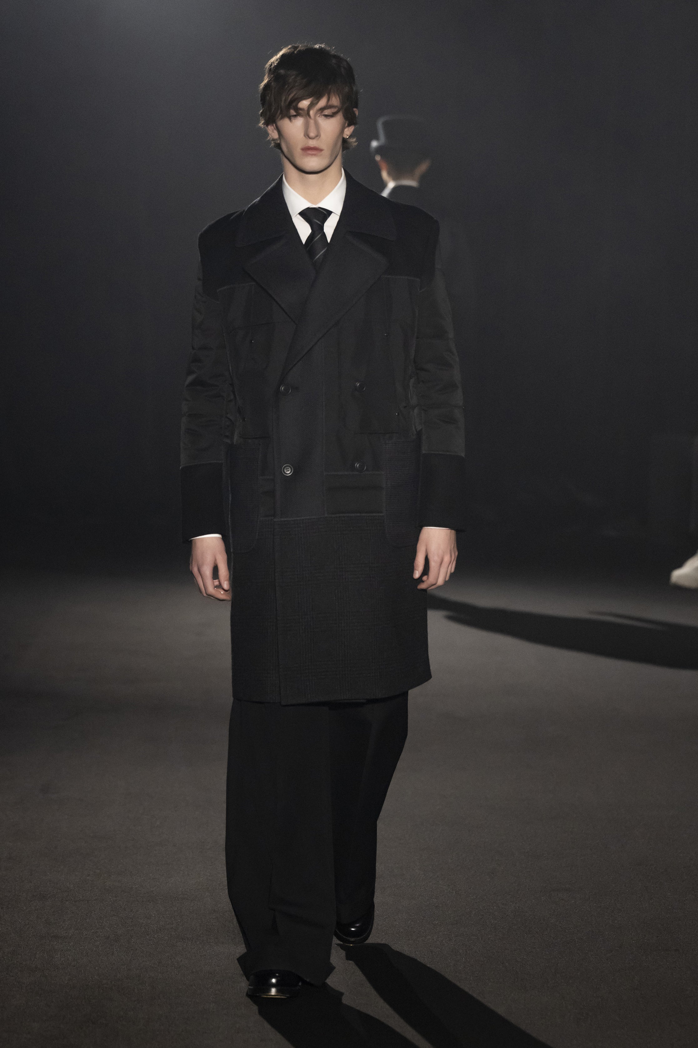 Fashion model wearing a JUNYA WATANABE MAN AW26 outfit